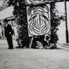 Unnamed Aboriginal woman in front of "Budget" welcome arch, Singleton 1904. Australian Museum.